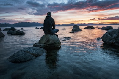 Person sitting calmly by water